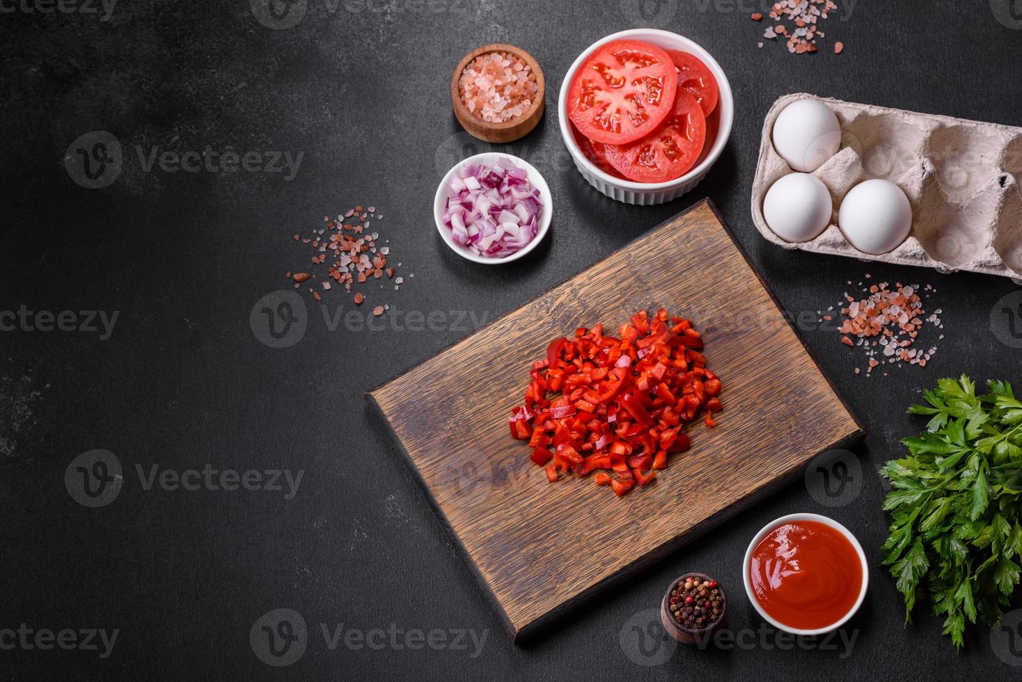 Ingredients for making shakshuka, dishes with fried eggs with tomato sauce, spices and herbs photo