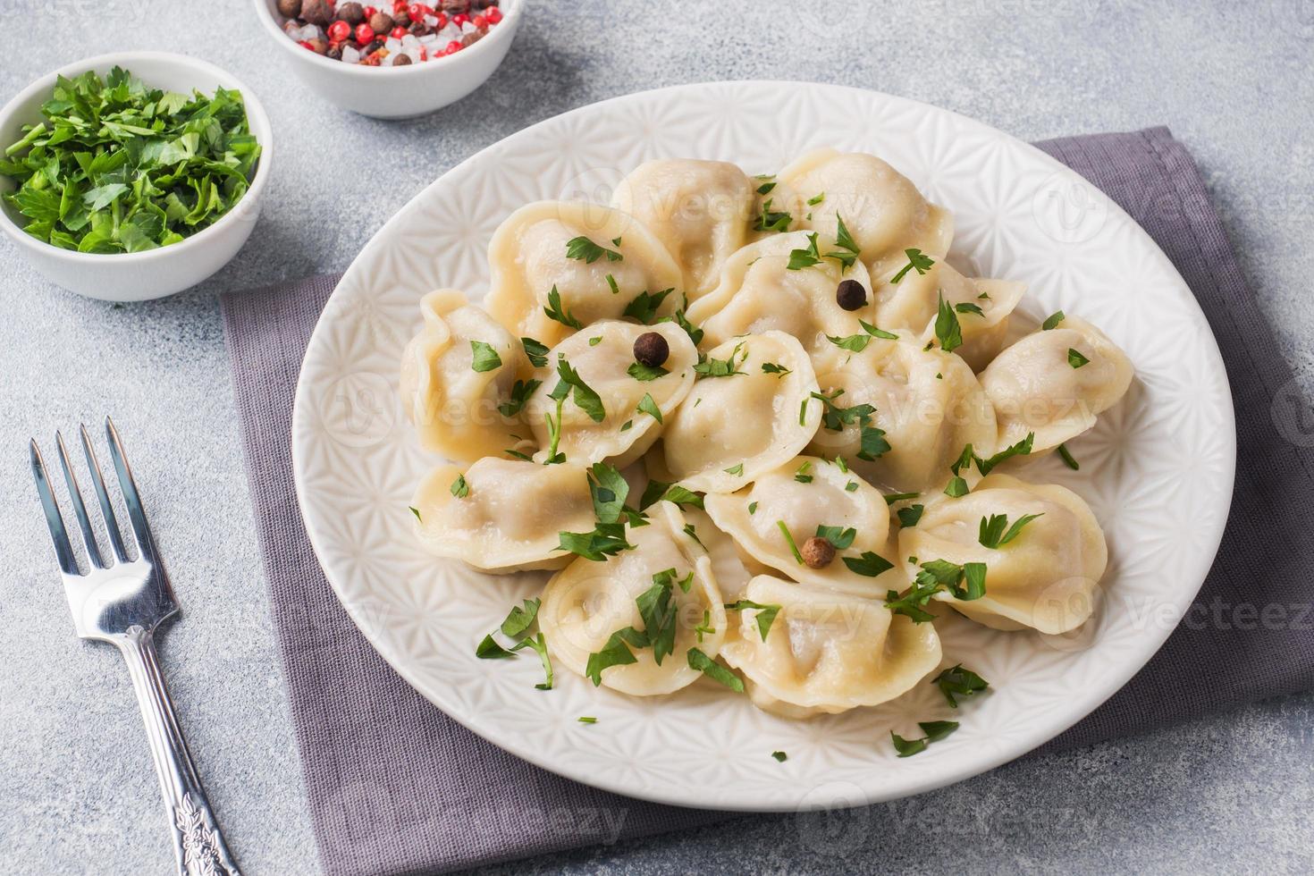 pelmeni tradicional, ravioli, albóndigas rellenas de carne en el plato, cocina rusa foto