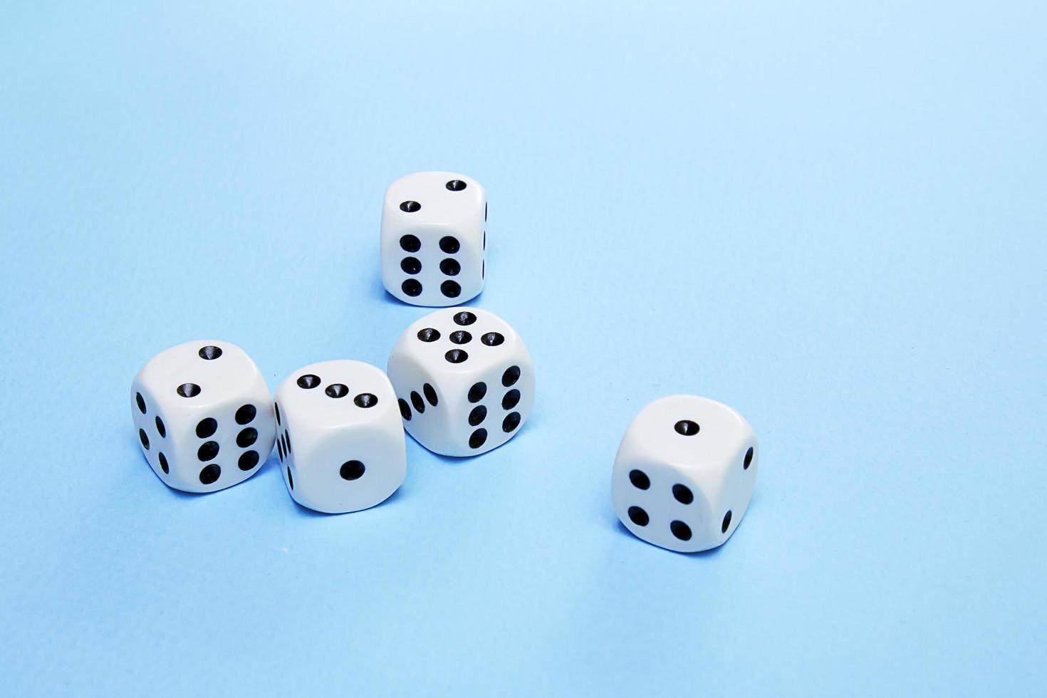 dice for the game are scattered on a blue field photo