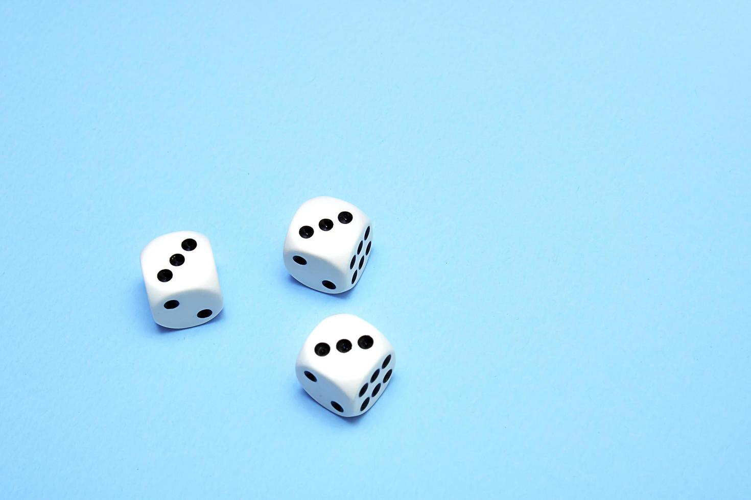 three dice with the same dropped out numbers lie on a blue background photo