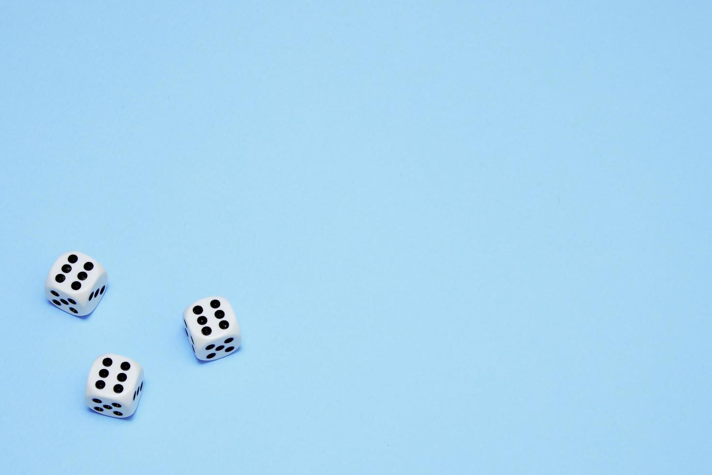 three dice with the same dropped out numbers lie on a blue background photo