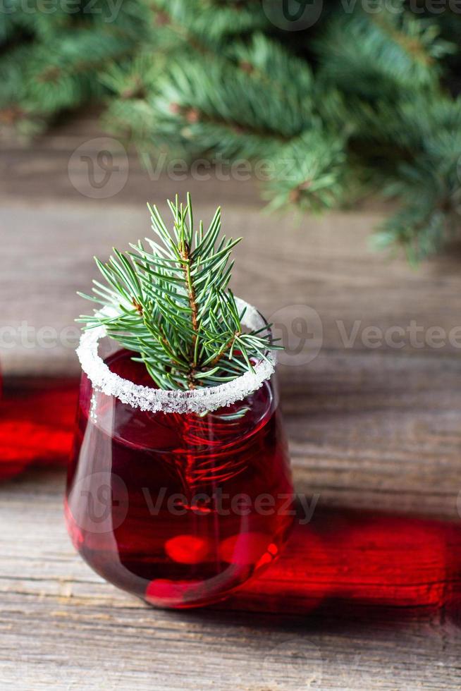 Cranberry red drink decorated with fir tree branches berry and sugar. Christmas hot mulled wine photo