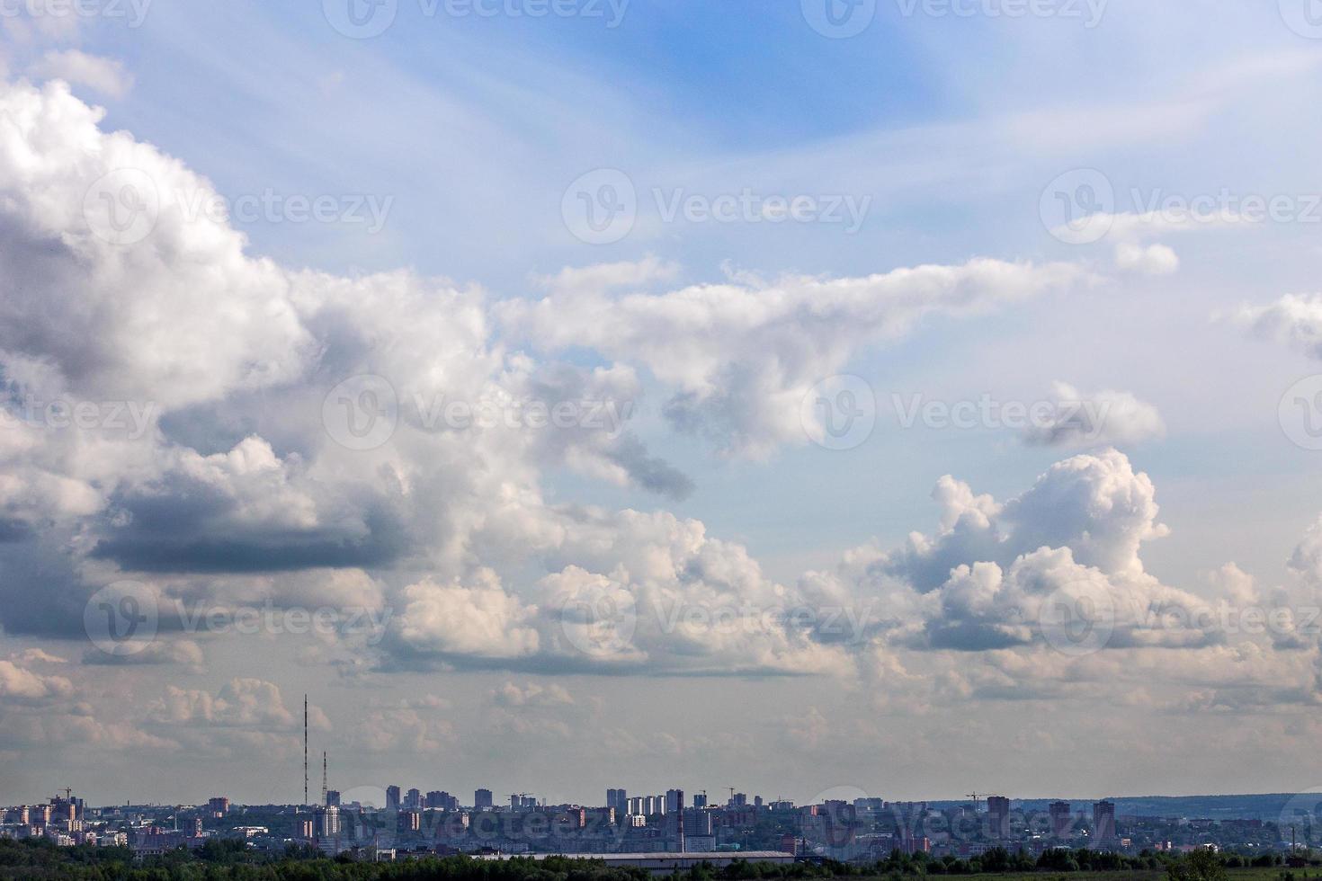 russian summer daylight cityscape with large cumulus clouds and tiny horizon line of the panel condominium houses photo