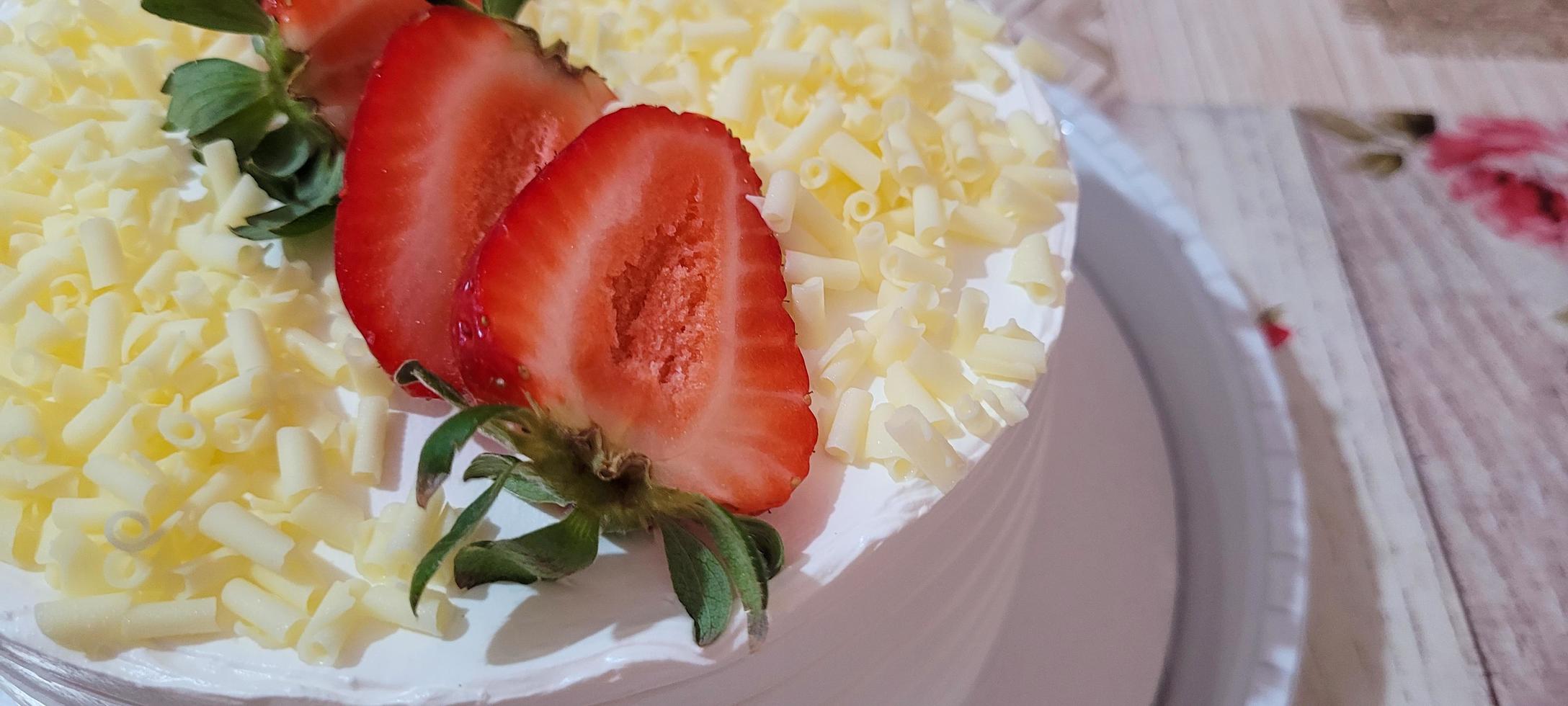 strawberry and whipped cream filled birthday cake photo