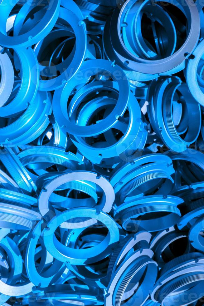 an abstract background of classic blue color coated metal ring parts photo