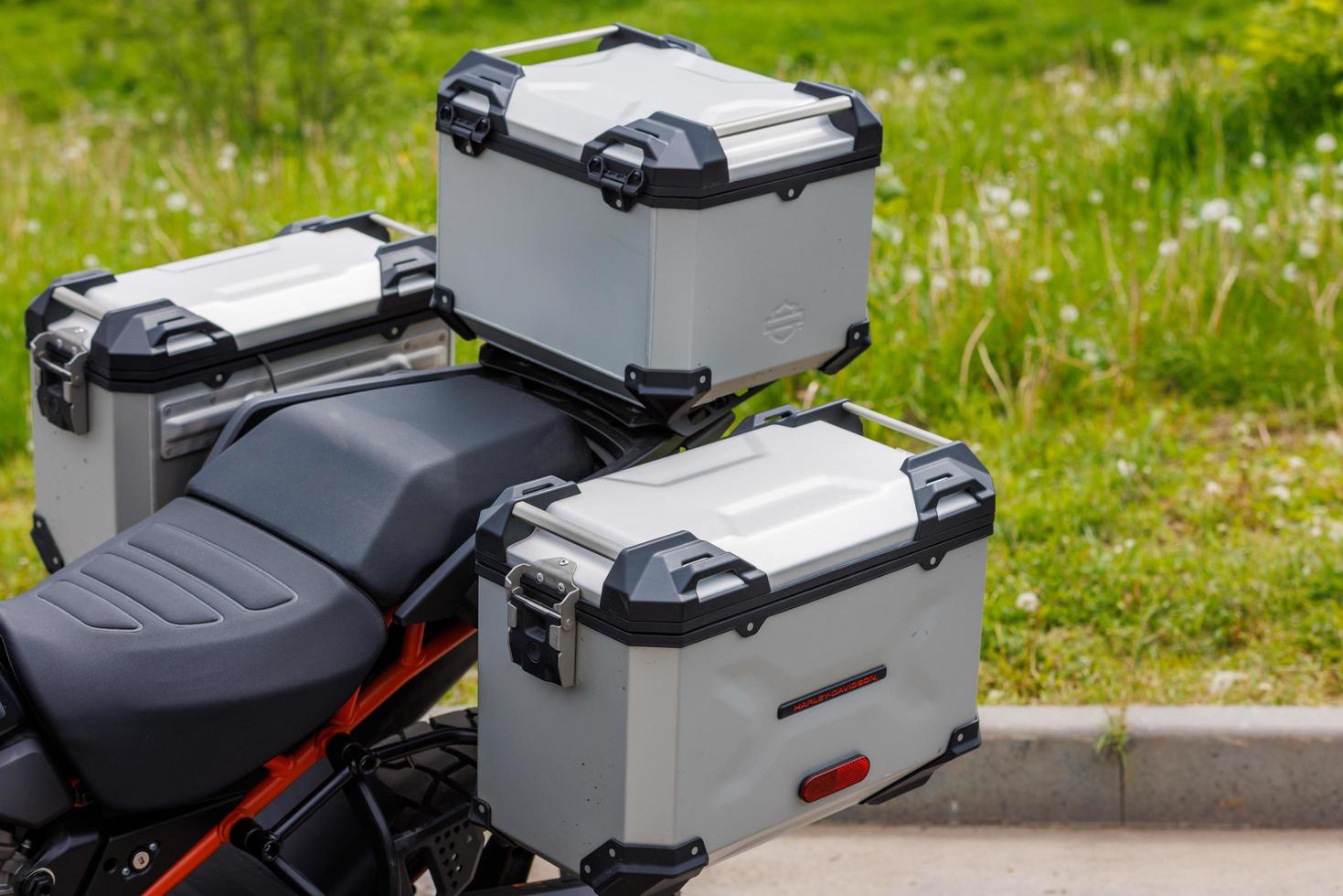 original side and top aluminium cases of Harley-Davidson motorcycle at summer day light, close-up photo