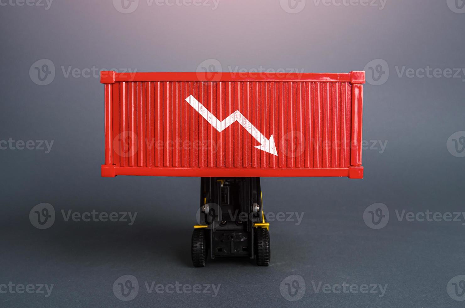 Red shipping container with down arrow. Decrease in imports and exports of goods. Trade traffic decreasing. Production fall. Lowering transportation prices. Decline in profits. Low shipping rates. photo