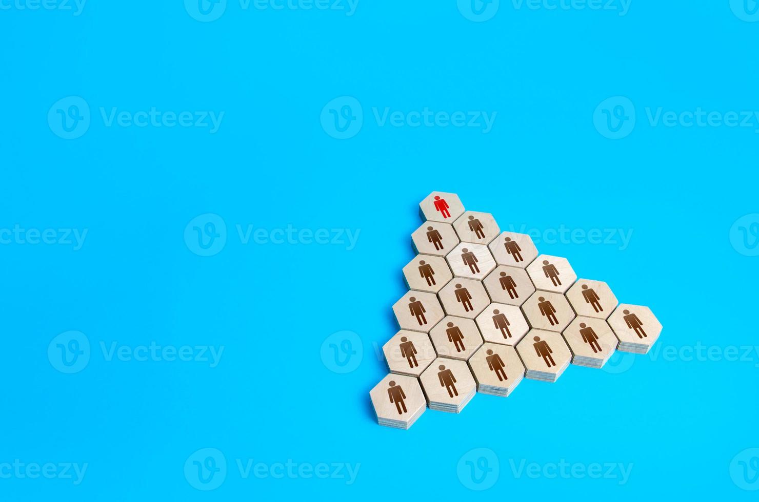 Leader at the head of hierarchical pyramid of the company. Traditional hierarchy concept. Superiors and subordinates. Meritocracy, corporate conformism. Personnel management. Cooperation and teamwork. photo