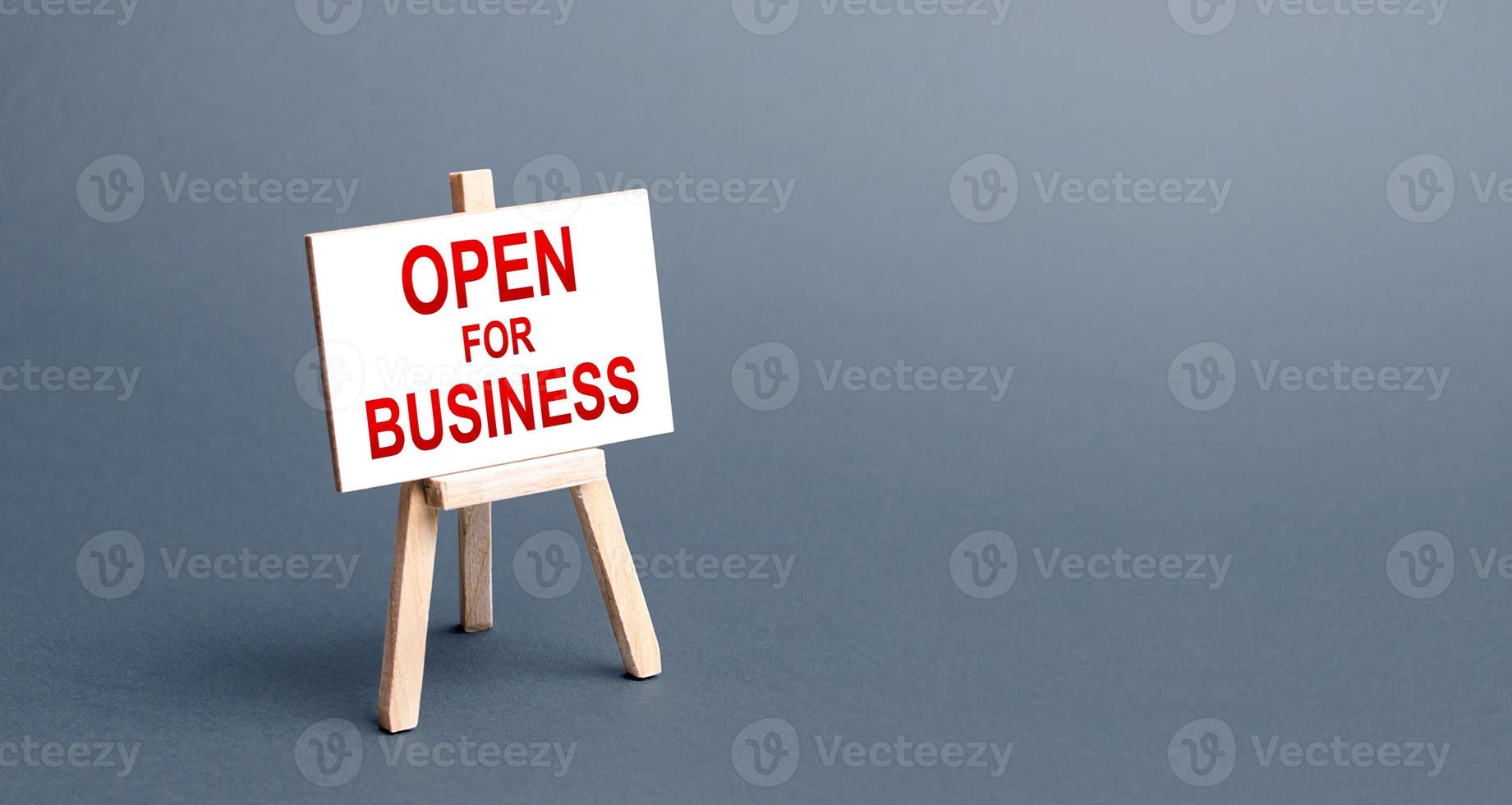 Open for business easel sign. Opening a business of establishments, resuming economic life after a long closure. Economy recovery from the crisis. Financial support, preferential cheap loans. photo