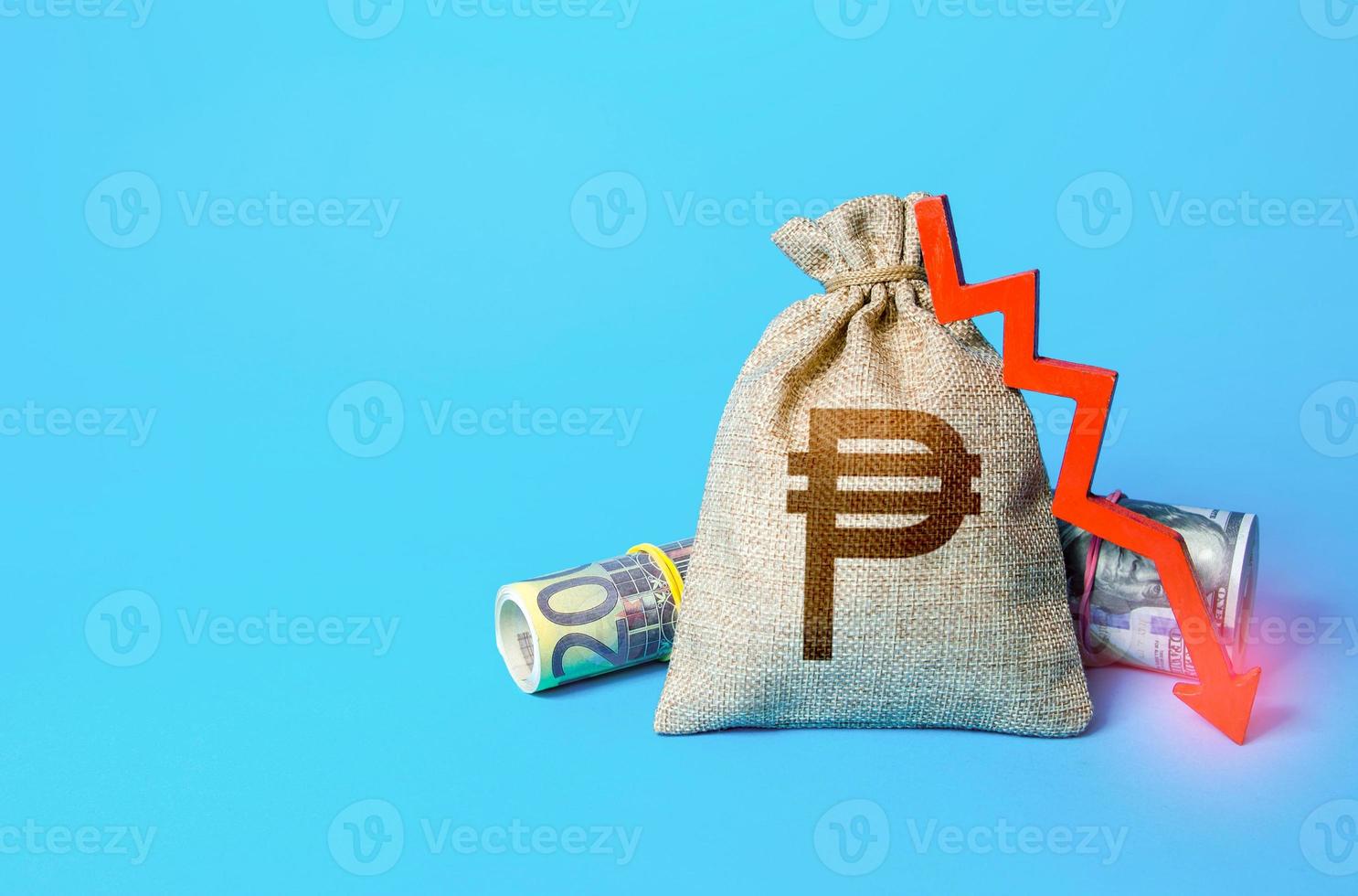 Philippine peso money bag and arrow down. Falling economy. Drop in profits. Decrease in interest rate deposit rate. Inflation. Low real incomes, economic difficulties. Recession and depression photo