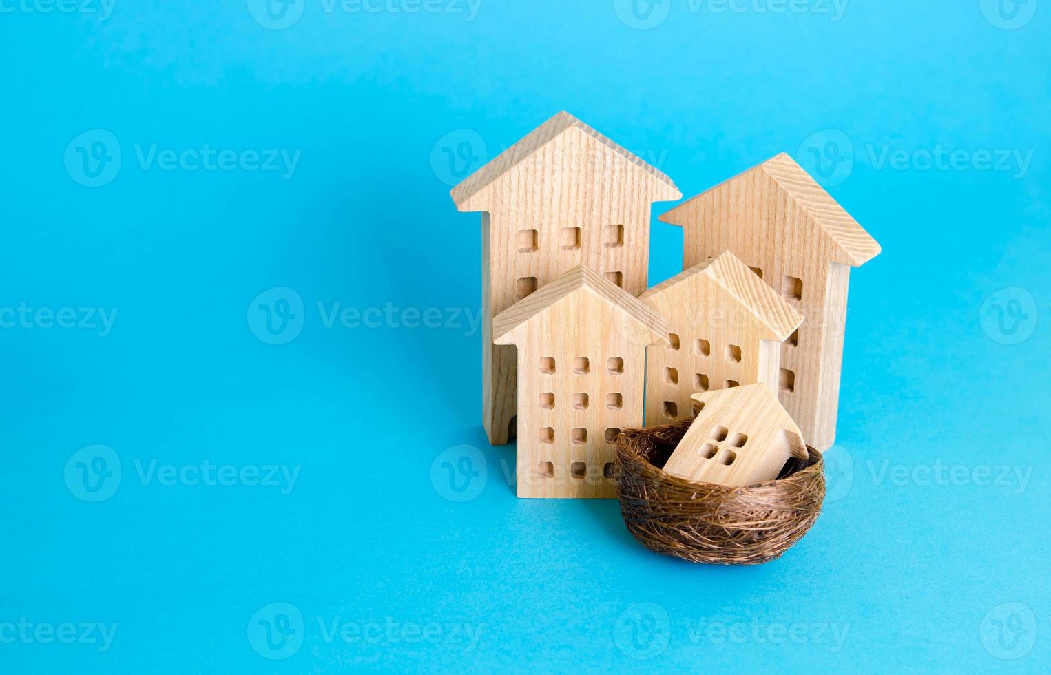 The metaphor of a family of houses. Parenting concept. Investing in real estate and construction industry. Mortgage. Buying a home for young families. Social support in purchase of housing. photo