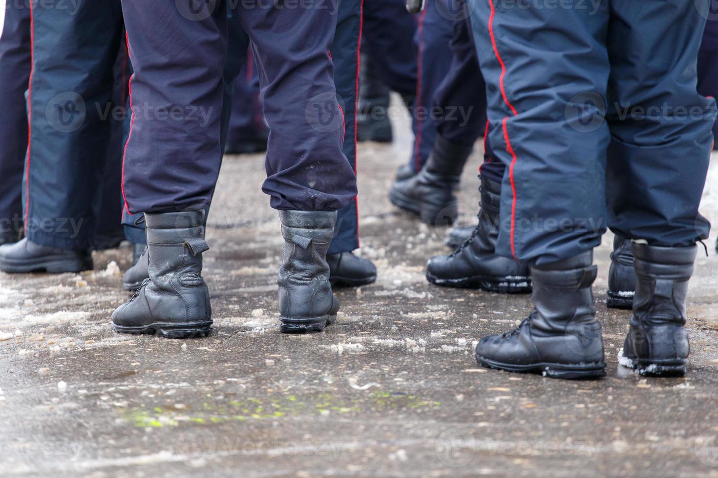 Russian police officers legs in black ankle boots - closeup with selective focus photo