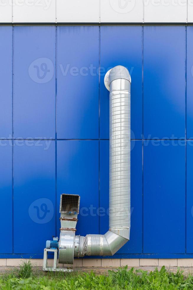 industrial grade air extraction duct with electrical motor on blue wall photo