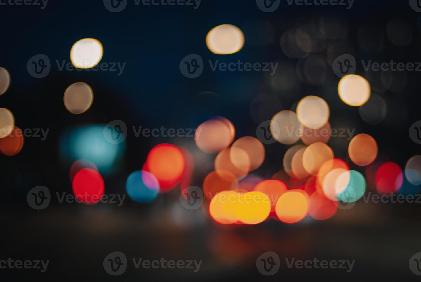 Bokeh street lights at night, blurry city traffic colors background