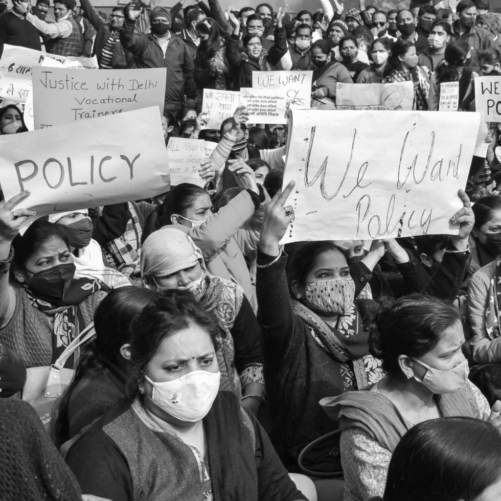 Delhi, India December 25 2021 - Delhi Contractual Guest Teachers with posters, flags and graffitis protesting against Delhi AAP Government for making policy, Delhi Teacher protesting Black and White photo