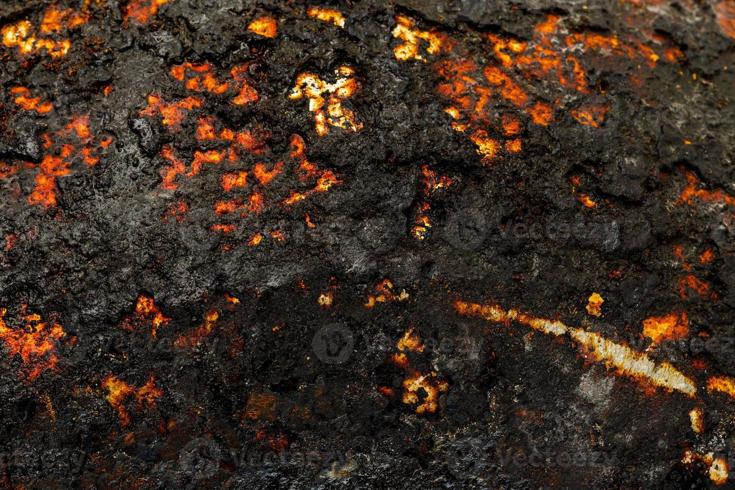 Bottom side of a cast iron pan with thicl layer of soot on it. photo