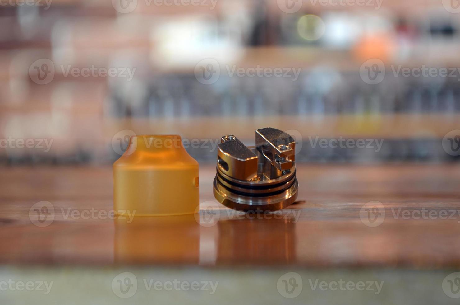 Electronic cigarette on a background of vape shop. E-cigarette for vaping. photo