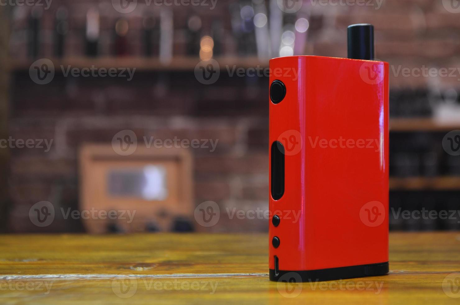 Electronic cigarette on a background of vape shop. E-cigarette for vaping. photo
