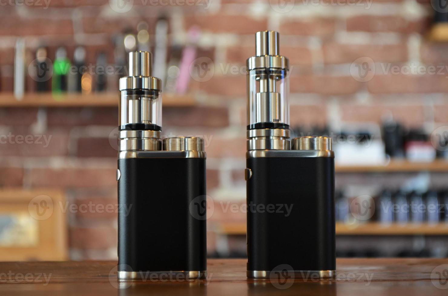 Electronic cigarette on a background of vape shop. E-cigarette for vaping. photo