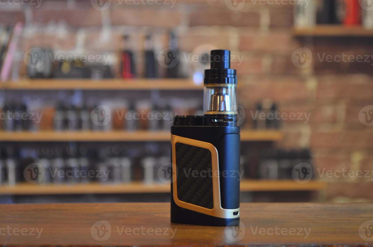 Electronic cigarette on a background of vape shop. E-cigarette for vaping. photo