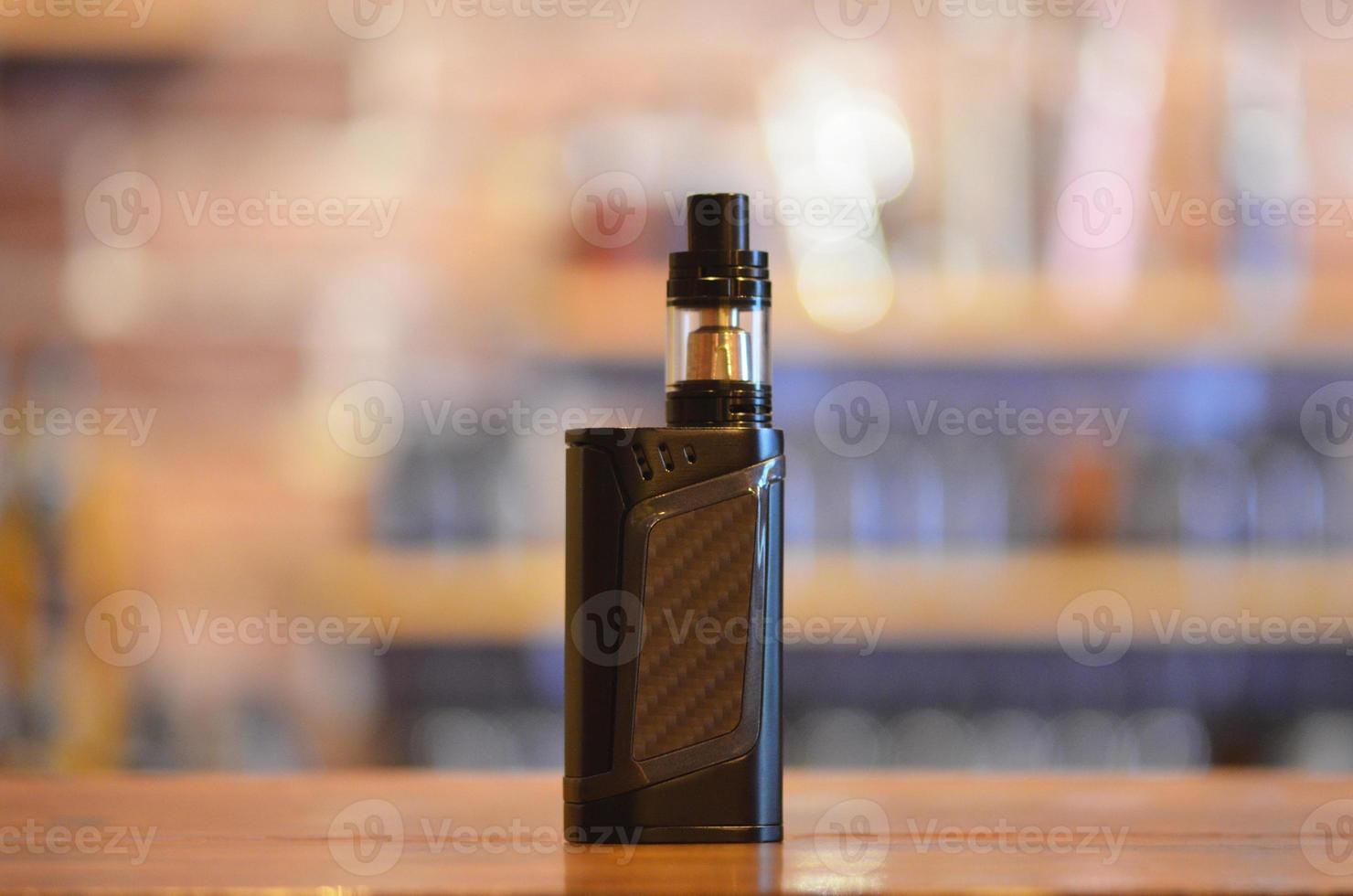 Electronic cigarette on a background of vape shop. E-cigarette for vaping. photo