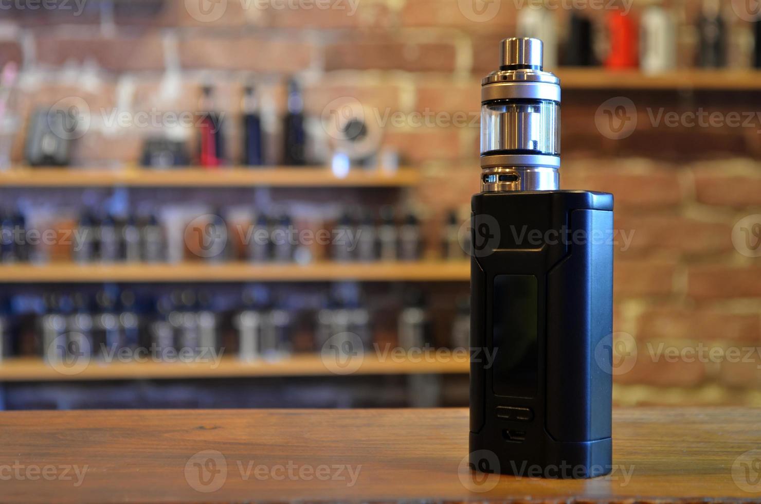 Electronic cigarette on a background of vape shop. E-cigarette for vaping. photo