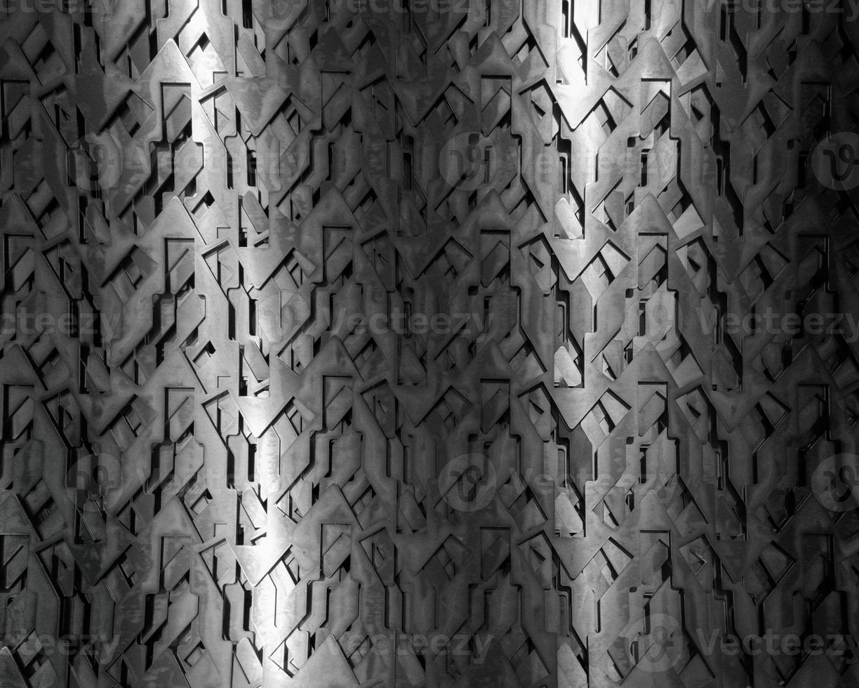 Light glow on grill pattern. Dark industrial abstract background. photo