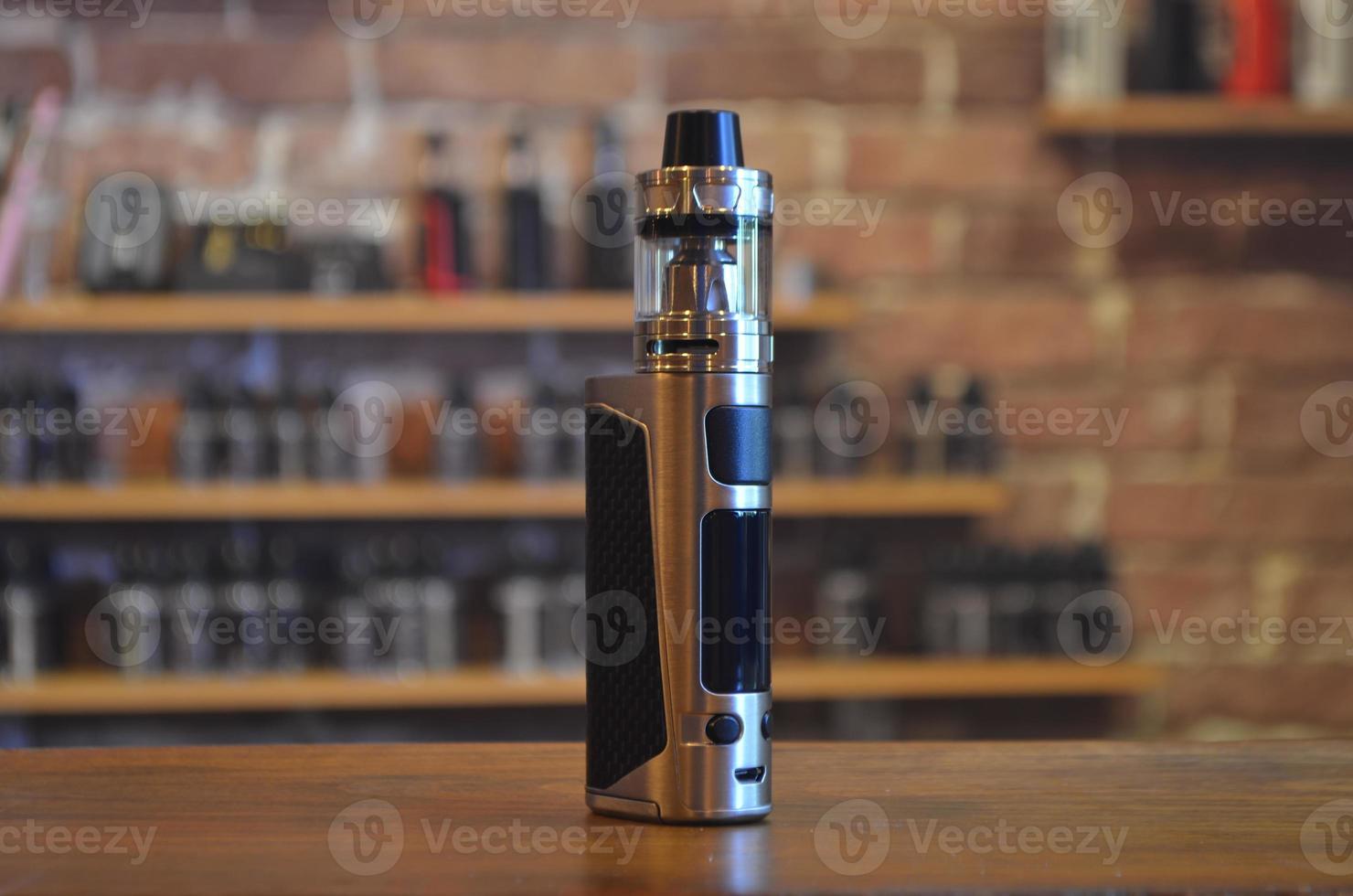 Electronic cigarette on a background of vape shop. E-cigarette for vaping. photo