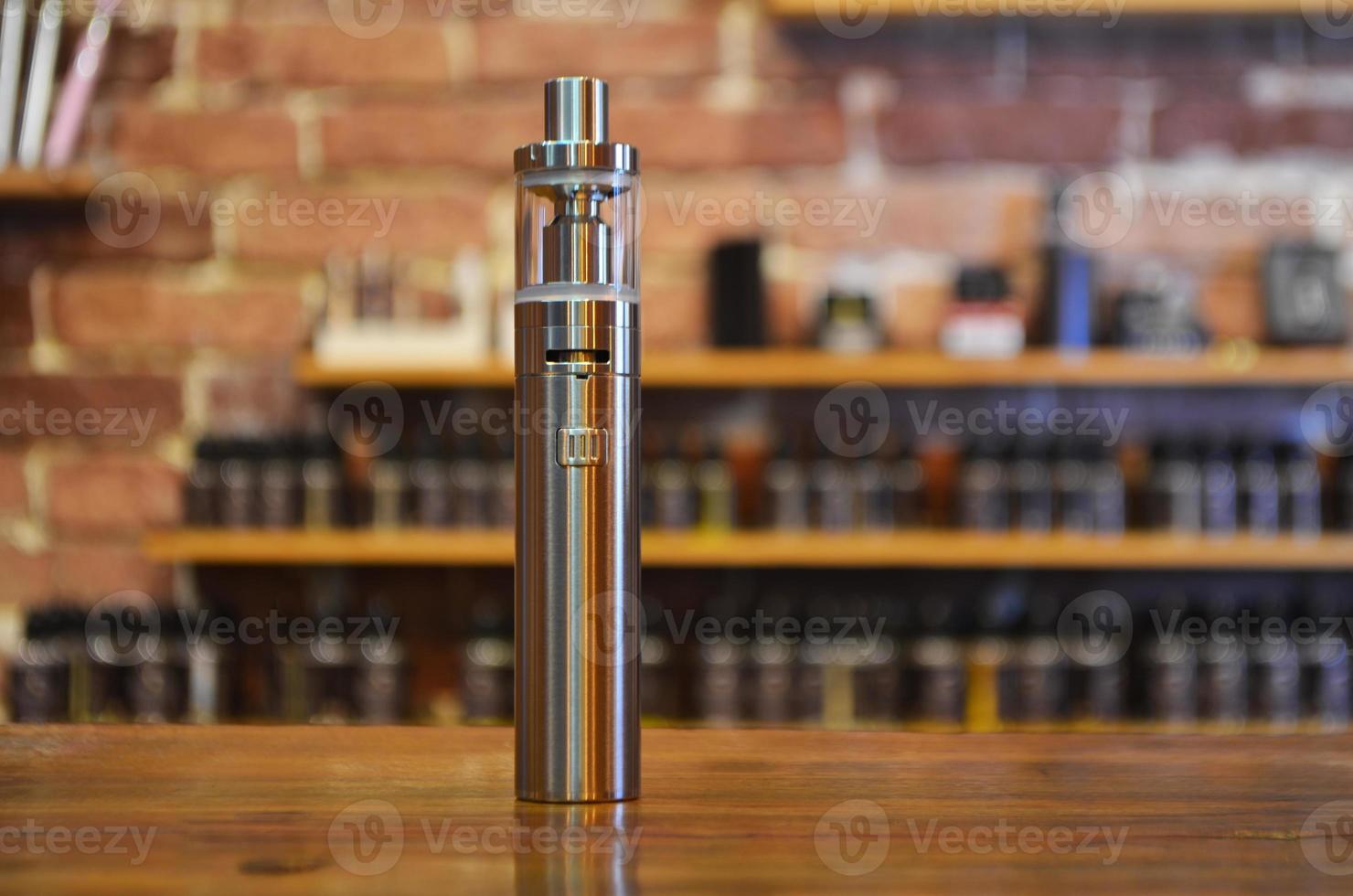 Electronic cigarette on a background of vape shop. E-cigarette for vaping. photo