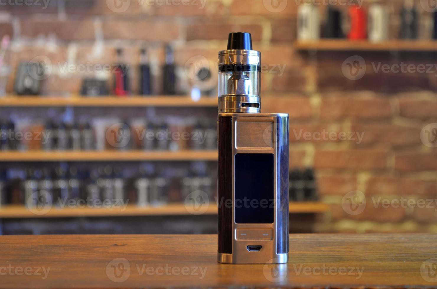 Electronic cigarette on a background of vape shop. E-cigarette for vaping. photo