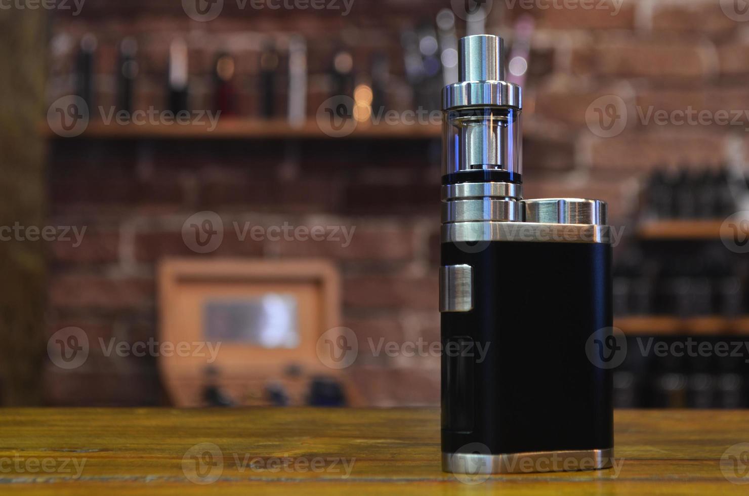 Electronic cigarette on a background of vape shop. E-cigarette for vaping. photo