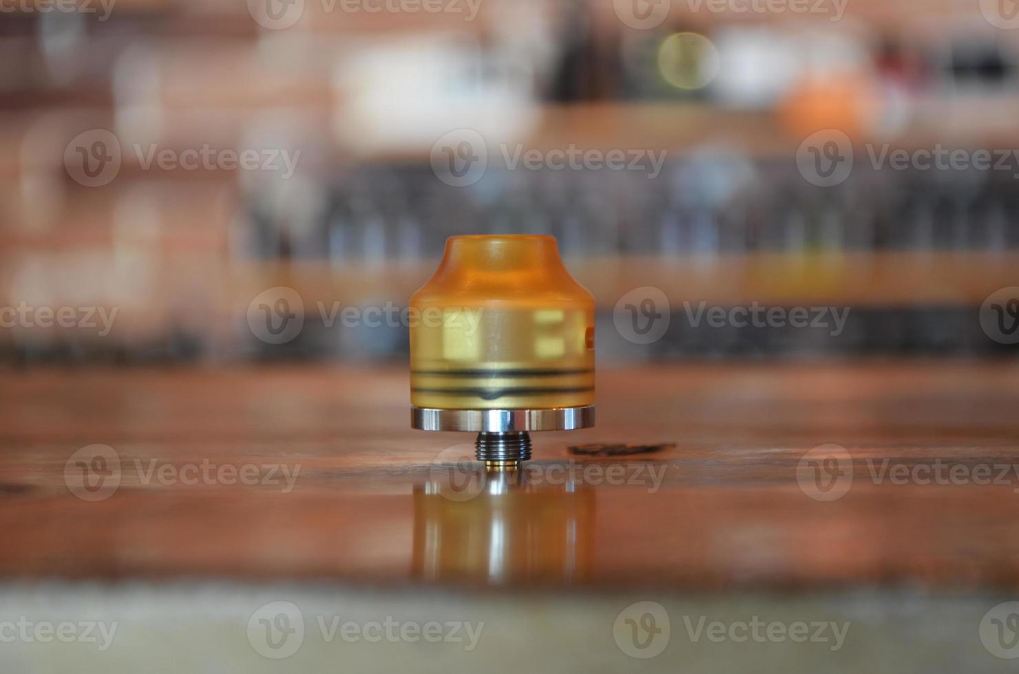 Electronic cigarette on a background of vape shop. E-cigarette for vaping. photo