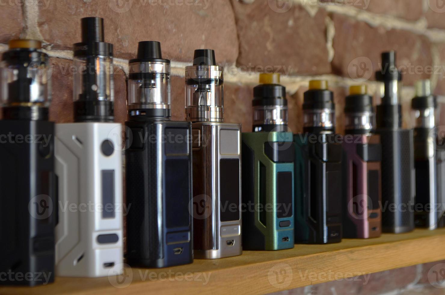 Electronic cigarette on a background of vape shop. E-cigarette for vaping. photo