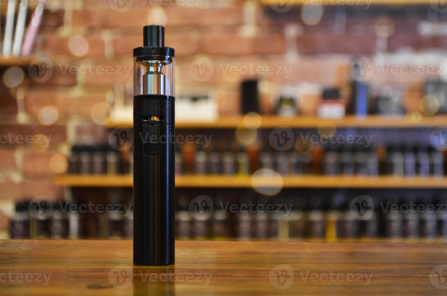 Electronic cigarette on a background of vape shop. E-cigarette for vaping. photo