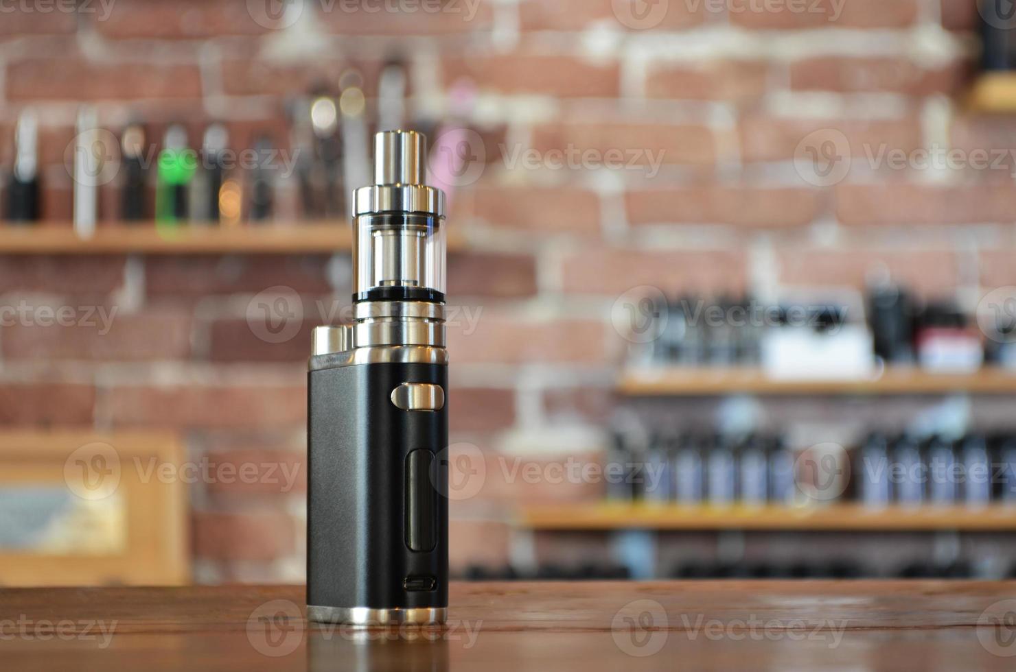 Electronic cigarette on a background of vape shop. E-cigarette for vaping. photo