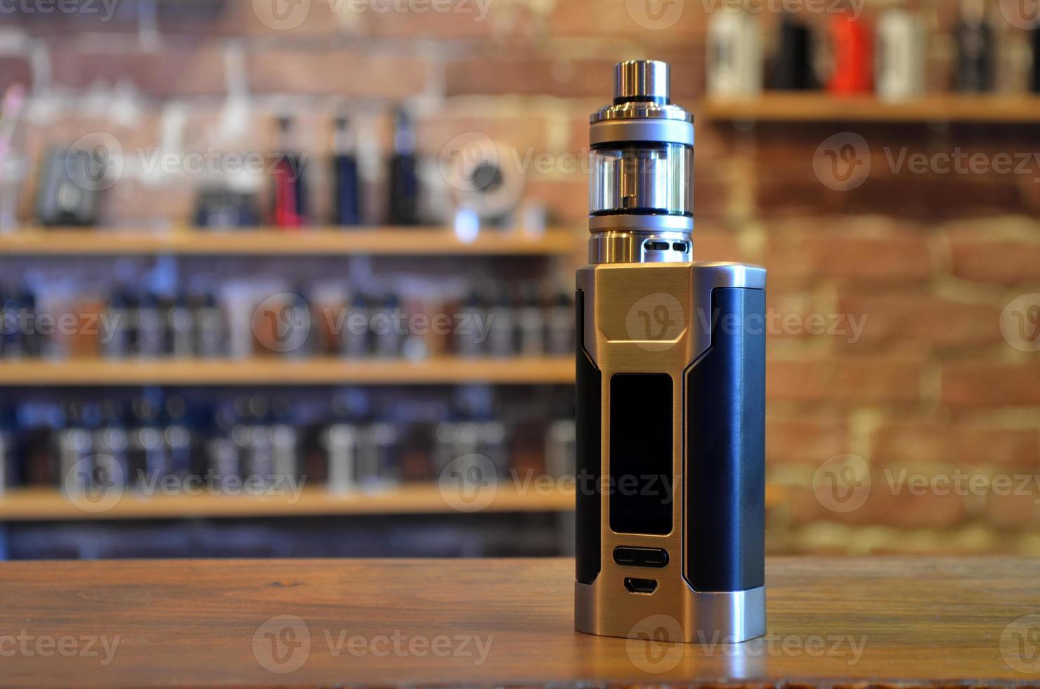Electronic cigarette on a background of vape shop. E-cigarette for vaping. photo