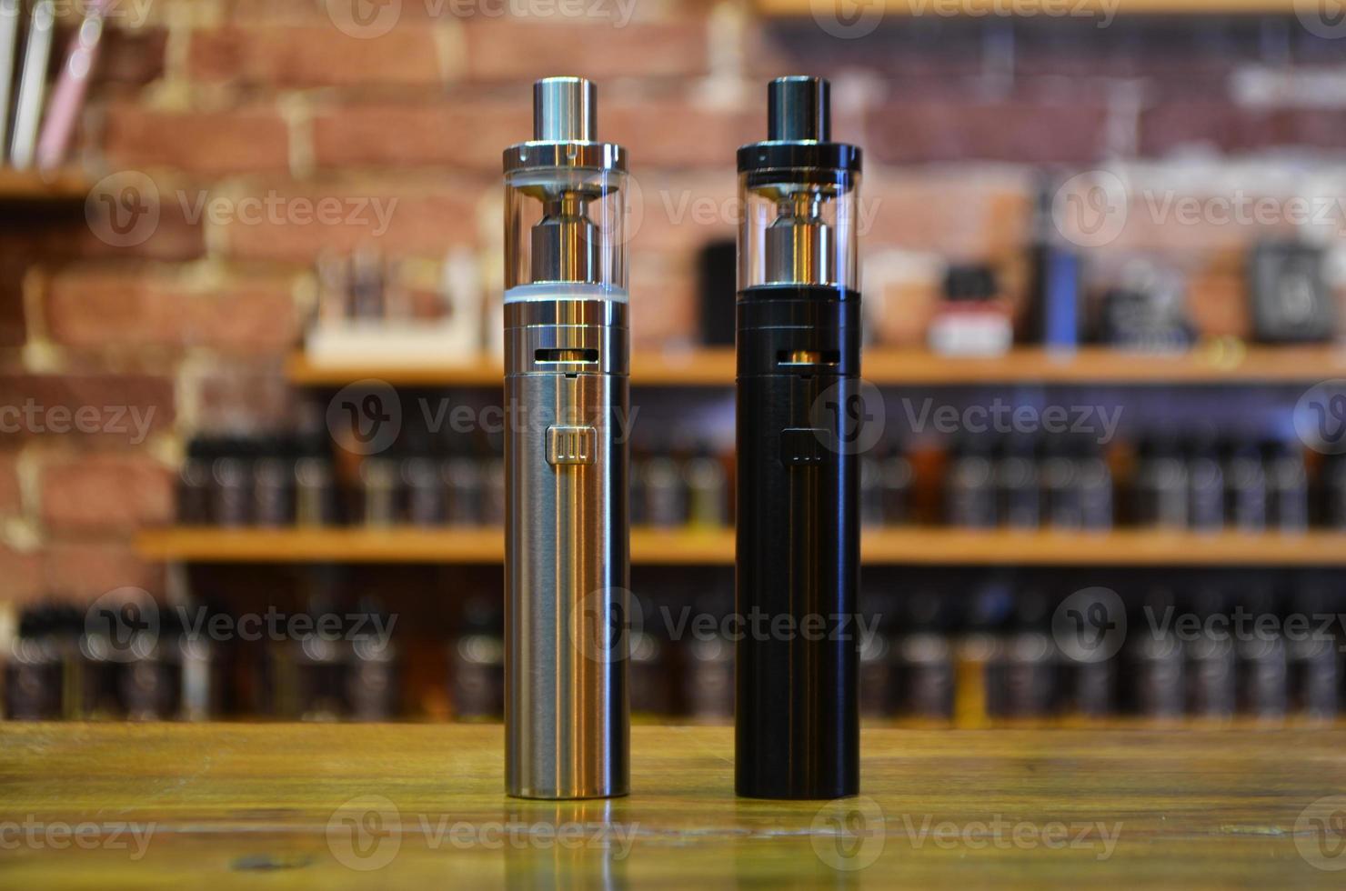 Electronic cigarette on a background of vape shop. E-cigarette for vaping. photo