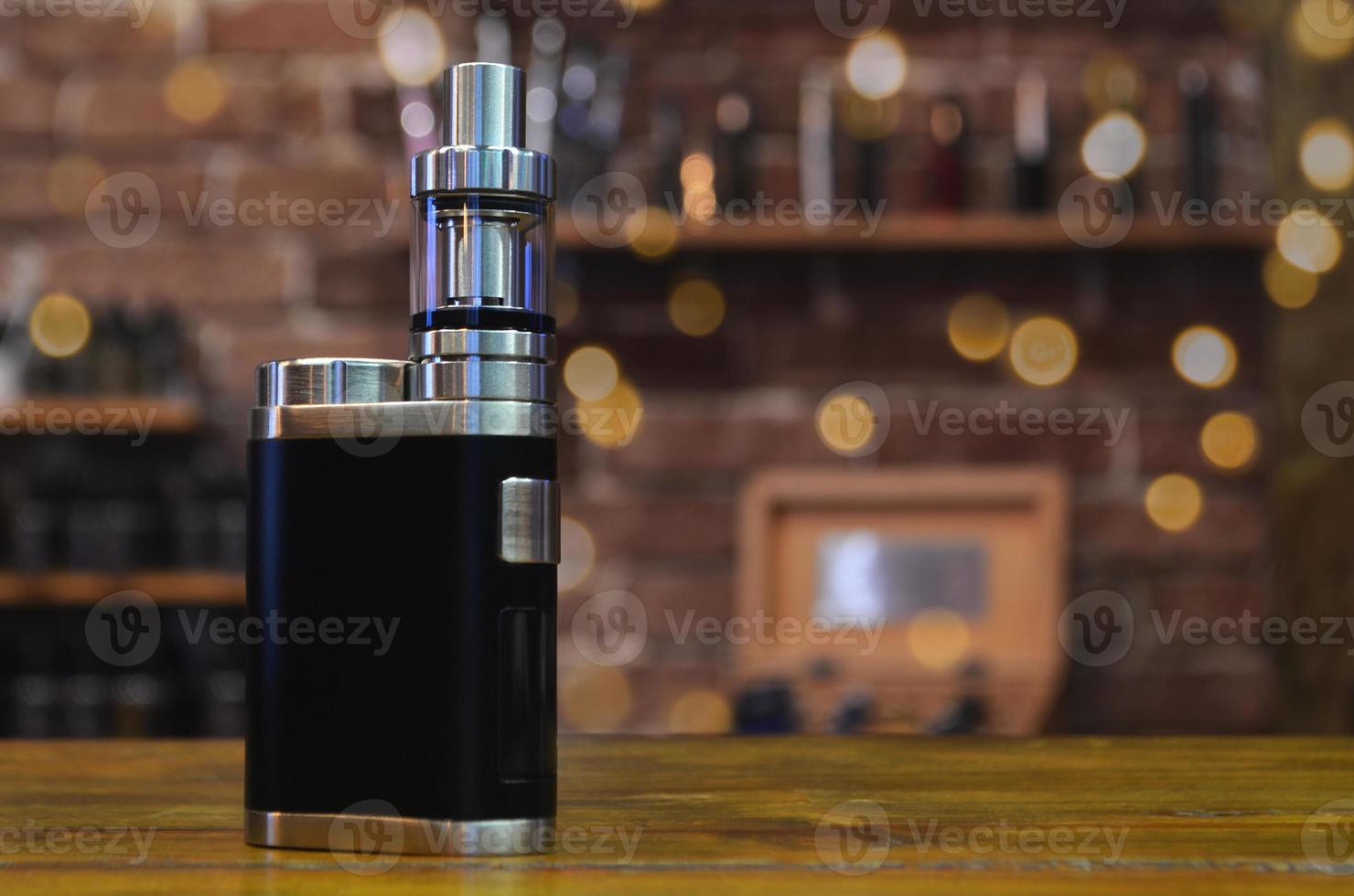 Electronic cigarette on a background of vape shop. E-cigarette for vaping. photo