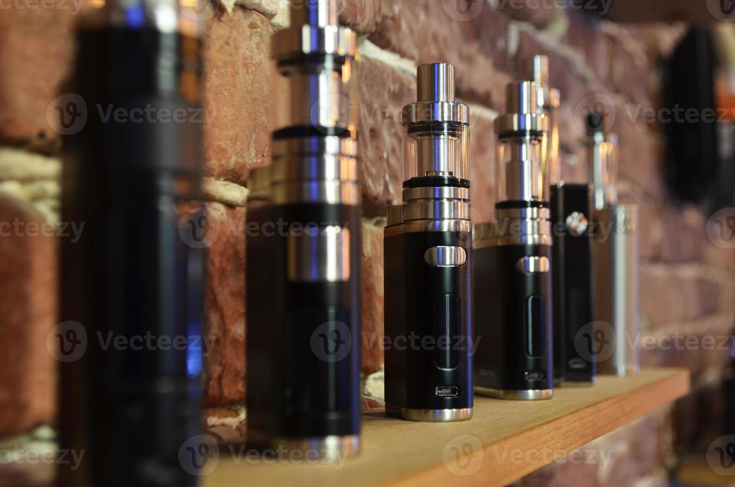 Electronic cigarette on a background of vape shop. E-cigarette for vaping. photo