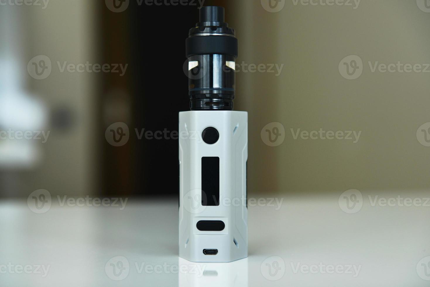 Electronic cigarette on a background of vape shop. E-cigarette for vaping. photo