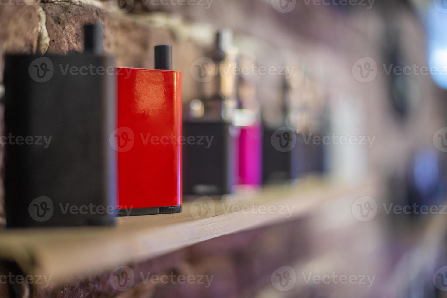 Electronic cigarette on a background of vape shop. E-cigarette for vaping. photo