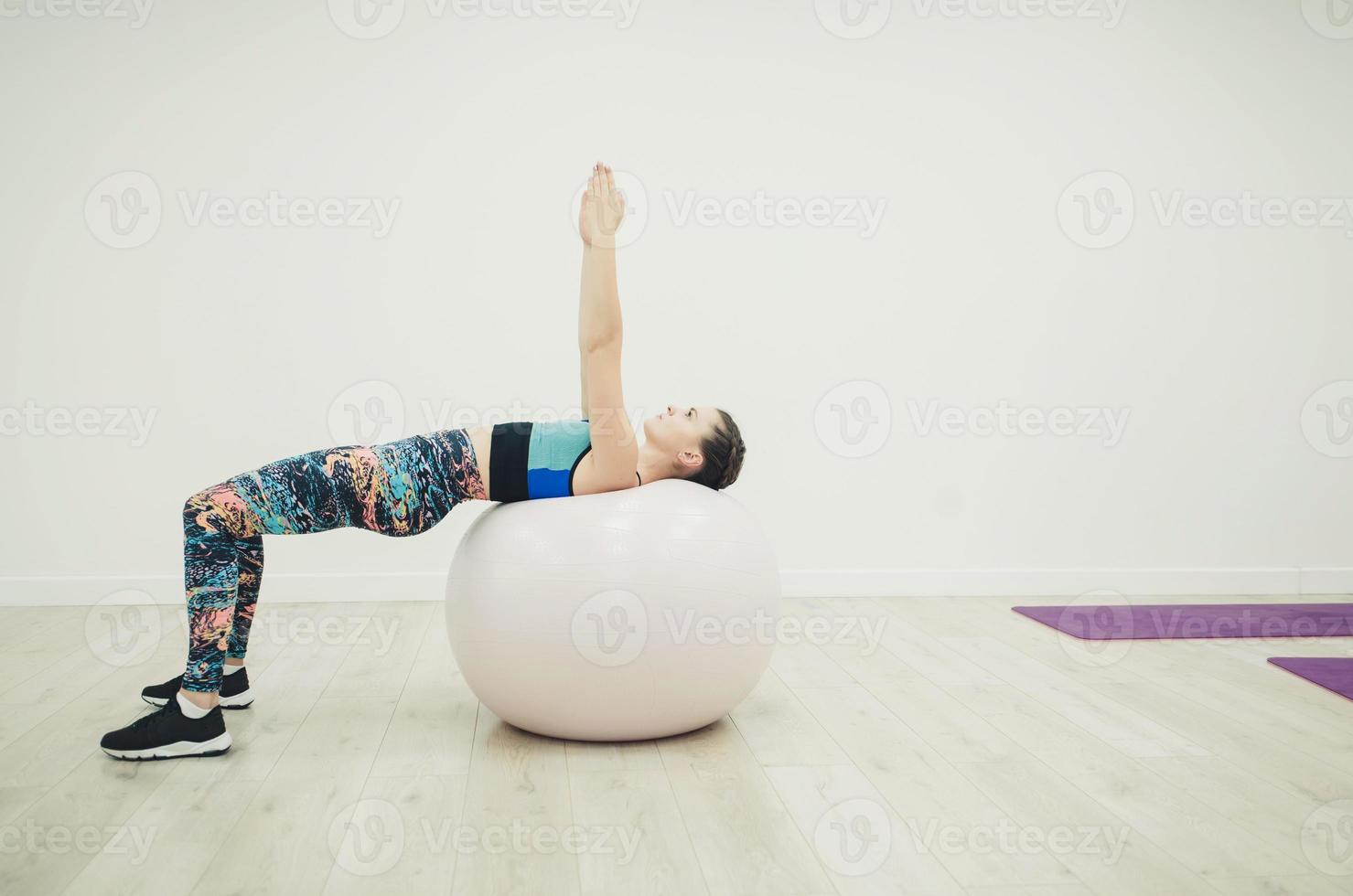 woman doing exercise on fitness ball photo