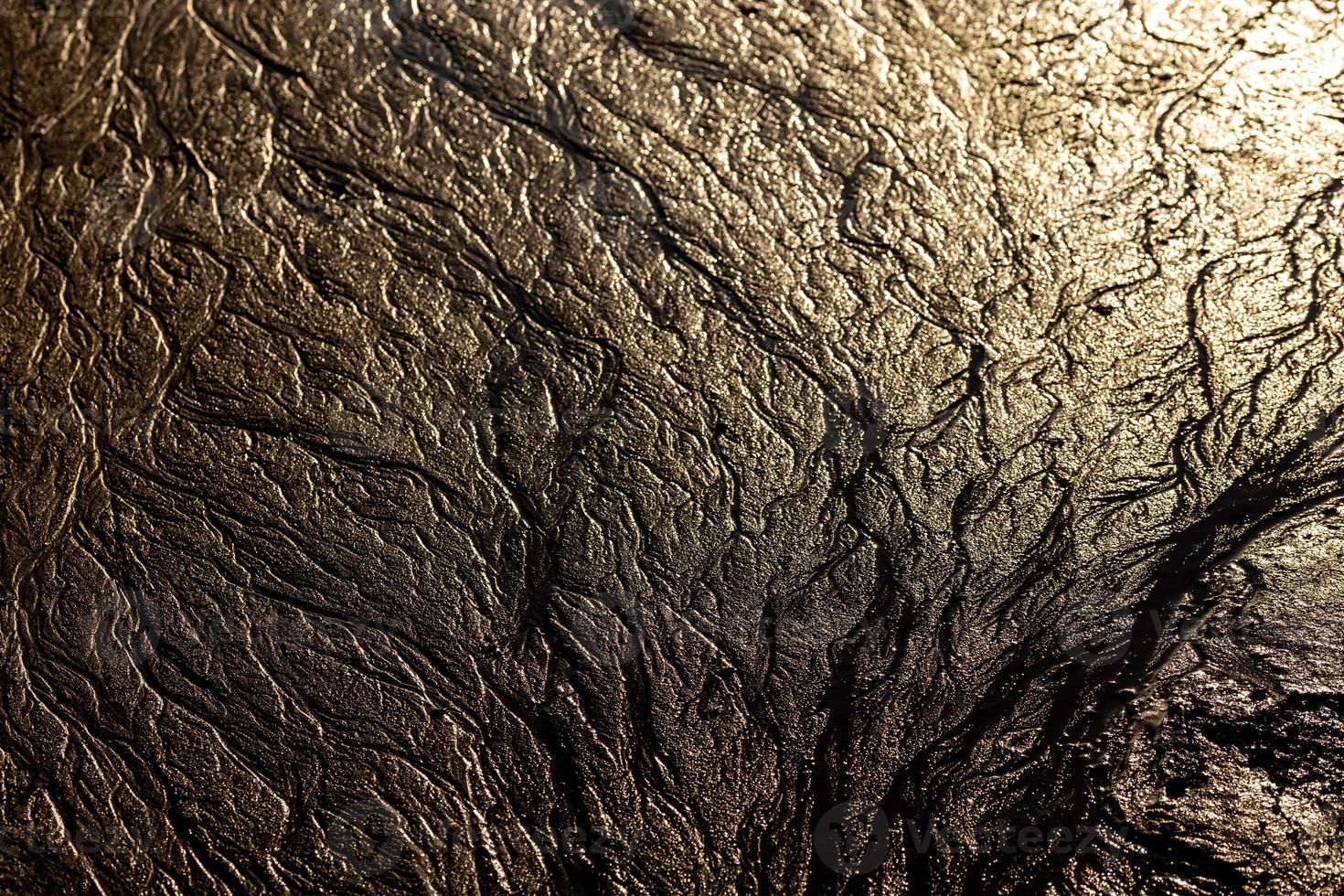 abstract mud background with water washout trails and selective focus photo
