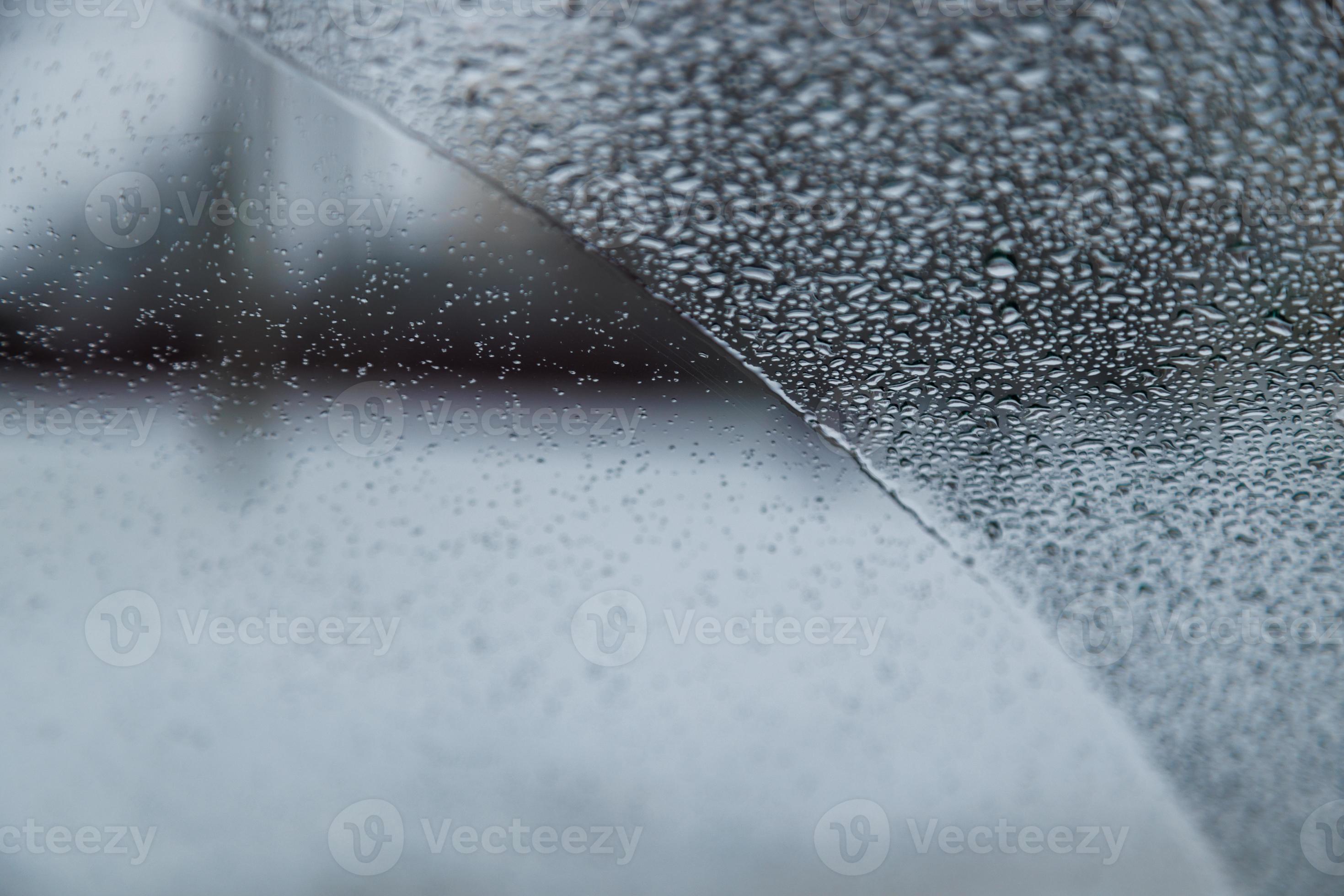 wet windshield vehicle glass covered with water drops partially wiped