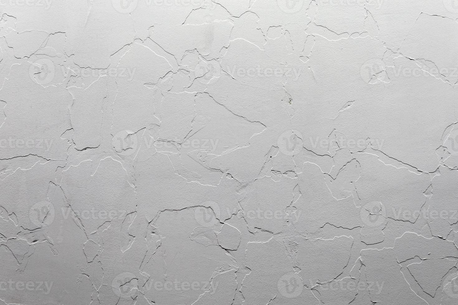 Abstract white unostentatious background and texture. A plaster wall with old cracked layer under new one. photo