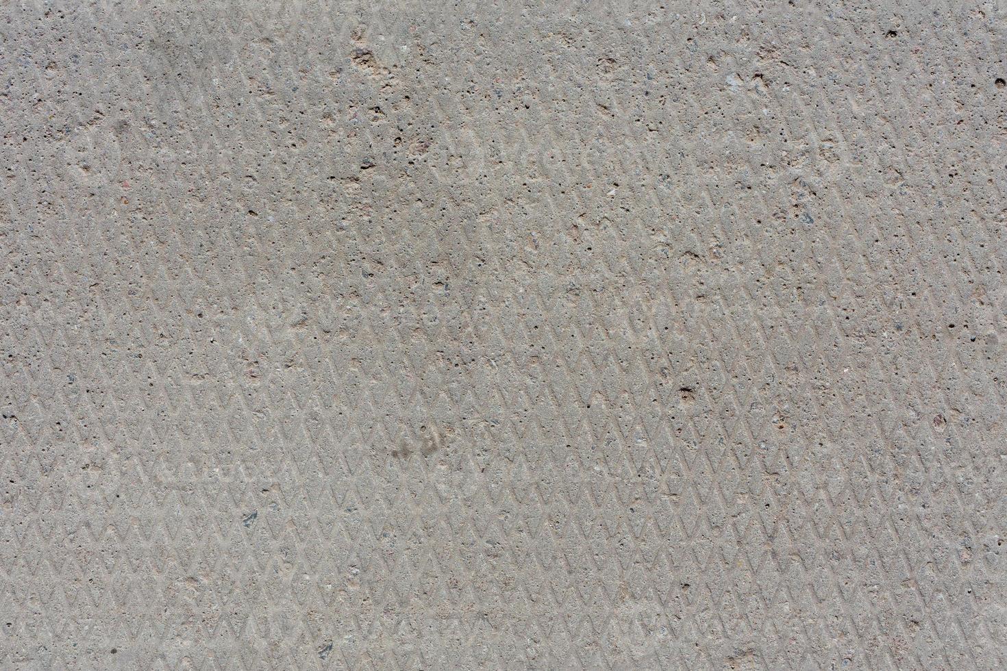 seamless texture and background of old flat dry concrete surface with diamond pattern and signs of light wearing photo