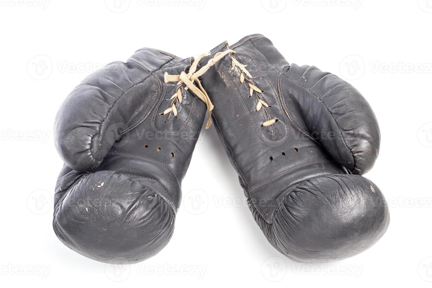 old black leather boxing gloves isolated on white background photo