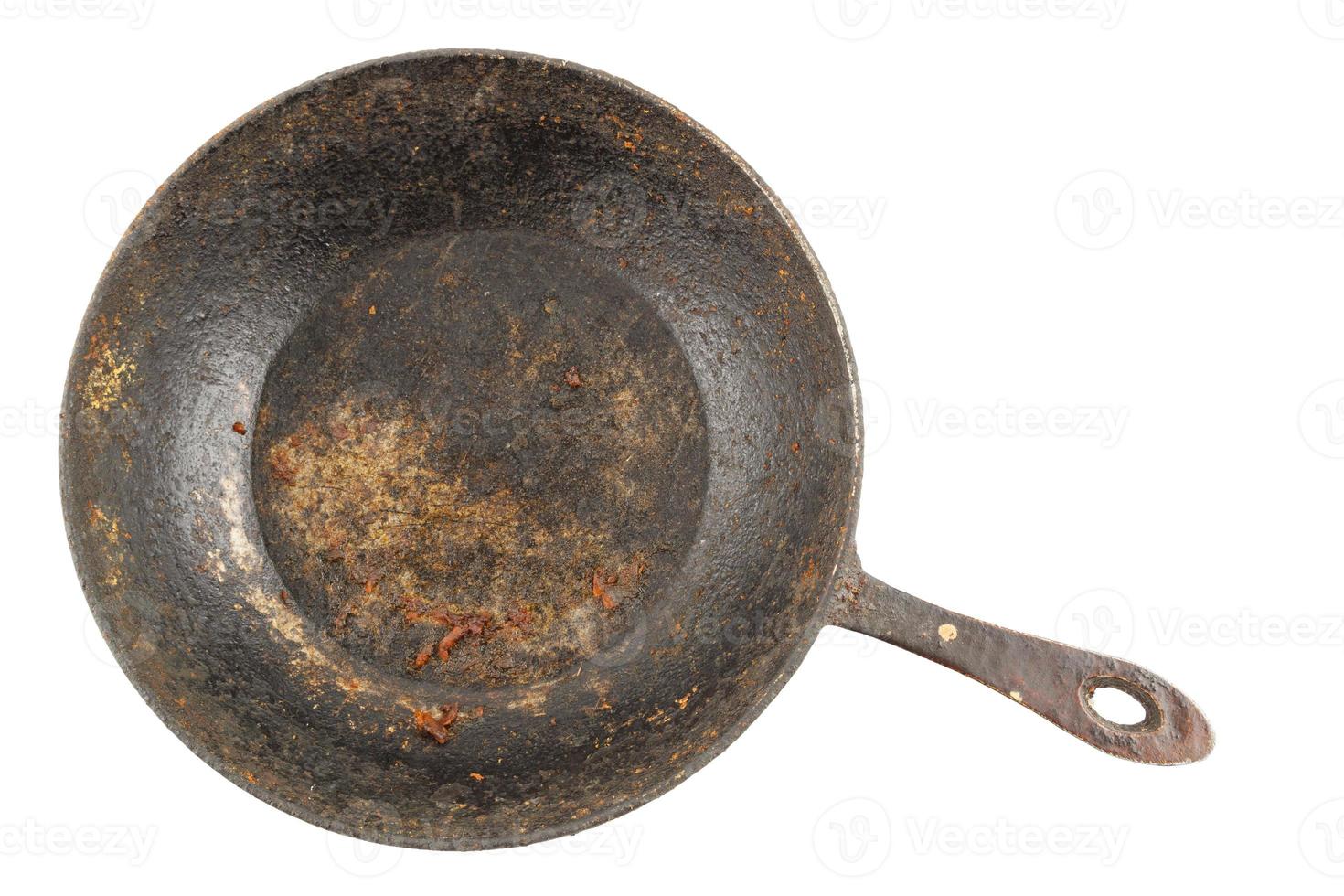 old disgusting stained rusty cast iron pan with burnt fat isolated in directly above perspective photo