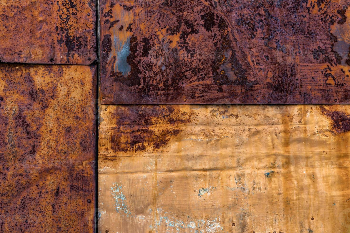 Rusted flat composite nailed metal sheets surface background and texture. photo