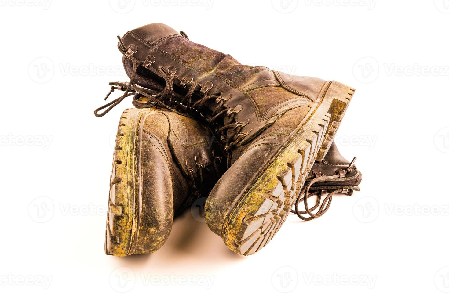 pair of dirty military style light ankle boots isolated on white background photo